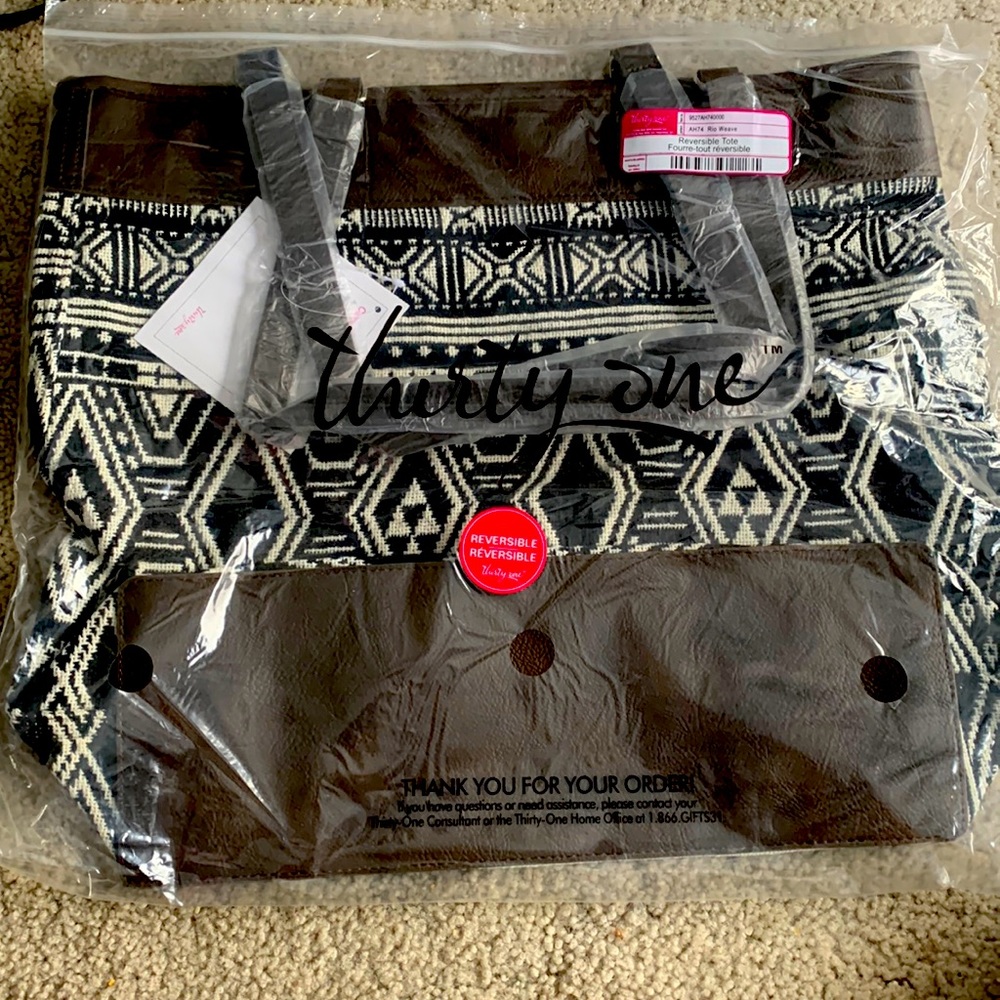 Thirty one reversible tote. New black and white with brown base trim and straps